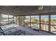 Relaxing screened porch with lounge chairs and hammock overlooking the ocean at 3408 Palmetto Blvd, Edisto Island, SC 29438