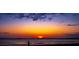 Sunset over the ocean with a silhouette of a person standing on the beach at 3408 Palmetto Blvd, Edisto Island, SC 29438