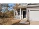 A detailed view of the front porch, with white pillars and a black front door at 3426 Kirkwall Dr, Summerville, SC 29485