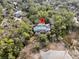 Aerial view of a beautiful home nestled among lush greenery, offering a private and serene setting at 4 Cedar Waxwing Ct, Kiawah Island, SC 29455