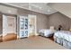 Neutral bedroom, featuring two twin beds, hardwood floors, and a doorway to bathroom at 4 Cedar Waxwing Ct, Kiawah Island, SC 29455