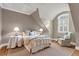 Cozy bedroom with a vaulted ceiling, complemented by a wrought iron bed frame and window at 4 Cedar Waxwing Ct, Kiawah Island, SC 29455