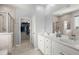 Bright bathroom featuring double sinks, white cabinetry, stand-up shower, walk-in closet and tile flooring at 407 Squire Pope Rd, Summerville, SC 29486