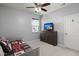 Neutral bedroom with carpeting, a ceiling fan, and large window, with a dresser featuring a mounted television at 407 Squire Pope Rd, Summerville, SC 29486