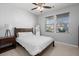 Comfortable bedroom with a dark wood bed frame, and large windows for natural light and a ceiling fan at 407 Squire Pope Rd, Summerville, SC 29486