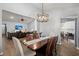 Bright dining room with hardwood floors, modern chandelier, and open to the living room at 407 Squire Pope Rd, Summerville, SC 29486