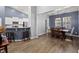 Open-concept dining area with hardwood floors, modern lighting, and seamless transition to the kitchen at 407 Squire Pope Rd, Summerville, SC 29486