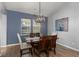 Dining room with a wooden dining table, a modern chandelier, and two windows at 407 Squire Pope Rd, Summerville, SC 29486