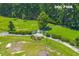 Aerial view of the fenced dog park with a grassy play area and shady spots for rest at 407 Squire Pope Rd, Summerville, SC 29486