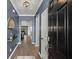 Elegant foyer with hardwood floors, modern light fixture, and an inviting view into the living spaces at 407 Squire Pope Rd, Summerville, SC 29486