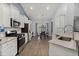Bright kitchen with stainless steel appliances, white cabinets, and an eat-in dining area at 407 Squire Pope Rd, Summerville, SC 29486