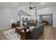 Spacious open-concept living room with vaulted ceilings, modern furniture, and seamless flow to the dining area at 407 Squire Pope Rd, Summerville, SC 29486