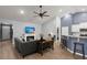 Bright and open living room with fireplace, ceiling fan and comfortable seating with easy access to kitchen at 407 Squire Pope Rd, Summerville, SC 29486