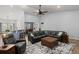 Spacious living room with a large sofa, stylish rug, and open layout, perfect for entertaining and relaxation at 407 Squire Pope Rd, Summerville, SC 29486