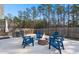 Beautiful backyard patio with a stone fire pit and Adirondack chairs, perfect for cozy outdoor evenings at 407 Squire Pope Rd, Summerville, SC 29486