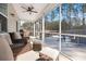 Relaxing screened porch featuring seating around a firepit with a view of the trees at 407 Squire Pope Rd, Summerville, SC 29486