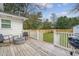 Inviting backyard deck with a fire pit, outdoor seating, and a grill, perfect for outdoor entertaining and relaxation at 4522 S Rhett Ave, North Charleston, SC 29405