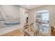 Open dining area with a modern glass table, connecting to the living room with stylish arched entryways at 4522 S Rhett Ave, North Charleston, SC 29405