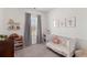 Charming Bedroom with a white crib, floral bedding, and decorative wall art at 454 Pender Woods Dr, Summerville, SC 29486