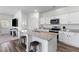 Modern kitchen boasts white cabinets, stainless steel appliances, and a functional island at 454 Pender Woods Dr, Summerville, SC 29486