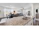Bright, open kitchen with stainless steel sink and a view of the cozy living area and dining nook at 454 Pender Woods Dr, Summerville, SC 29486