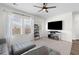 Bright living room with a large TV, neutral carpet, and a view of the backyard through the windows at 454 Pender Woods Dr, Summerville, SC 29486