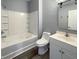 This bathroom has a combo tub and shower with new white tile and a white vanity at 4666 Palm View Cir, North Charleston, SC 29418