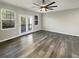 Spacious living room features hardwood floors, large windows, and a modern ceiling fan with light fixture at 4666 Palm View Cir, North Charleston, SC 29418