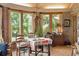 Sunroom dining area featuring tiled floors, large windows offering plenty of natural light, and brick walls at 528 Wampler Dr, Charleston, SC 29412