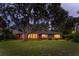 Exterior view of a charming home at night with manicured lawn and warm, inviting lighting at 528 Wampler Dr, Charleston, SC 29412