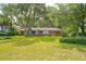 Spacious front yard with a brick house and mature shade trees in a residential neighborhood at 528 Wampler Dr, Charleston, SC 29412