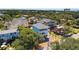 Aerial view of the blue house, highlighting mature trees and surrounding neighborhood at 74 Sandbar Ln, Folly Beach, SC 29439