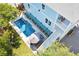 Aerial view of a two-story blue house, showing a private pool, deck, and covered porch at 74 Sandbar Ln, Folly Beach, SC 29439