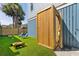 Lush backyard featuring a convenient outdoor shower, two lounge chairs and an adjacent grassy area at 74 Sandbar Ln, Folly Beach, SC 29439