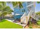 Lovely backyard with a pool, outdoor seating, and stairs leading to the home's upper level at 74 Sandbar Ln, Folly Beach, SC 29439