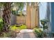Backyard view with an enclosed outdoor shower, stone pathway, and lush landscaping at 74 Sandbar Ln, Folly Beach, SC 29439
