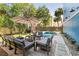 Inviting backyard featuring a pool, patio seating area, grill, and a well-manicured lawn at 74 Sandbar Ln, Folly Beach, SC 29439