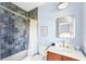 Stylish bathroom showcasing a tiled shower, a modern vanity, and blue walls at 74 Sandbar Ln, Folly Beach, SC 29439