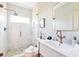 Bright bathroom featuring a glass shower, and modern vanity with bronze fixtures at 74 Sandbar Ln, Folly Beach, SC 29439