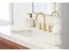Close-up of a modern bathroom sink, featuring marble countertops and gold fixtures at 74 Sandbar Ln, Folly Beach, SC 29439