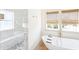 Chic bathroom showcasing a glass shower, standalone tub, stylish tiles, and natural light at 74 Sandbar Ln, Folly Beach, SC 29439