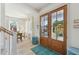 Bright entryway with wood flooring, a view to the dining area, and double doors to the balcony at 74 Sandbar Ln, Folly Beach, SC 29439