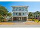 Beautiful raised beach house with double porches and a spacious driveway, perfect for coastal living at 74 Sandbar Ln, Folly Beach, SC 29439