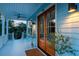 Charming front porch featuring double doors, stylish lighting, and potted greenery at 74 Sandbar Ln, Folly Beach, SC 29439