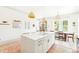 Kitchen island with barstool seating beneath pendant lights, next to dining area at 74 Sandbar Ln, Folly Beach, SC 29439