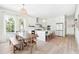 Open-concept kitchen and dining area with modern finishes, a large island, and bright windows at 74 Sandbar Ln, Folly Beach, SC 29439
