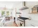 Elegant kitchen with stainless steel appliances, marble countertops, and a view to the dining area at 74 Sandbar Ln, Folly Beach, SC 29439