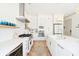Modern kitchen featuring white cabinetry, marble countertops, and a stainless-steel appliance package at 74 Sandbar Ln, Folly Beach, SC 29439