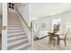 Bright living room adjacent to staircase with hardwood floors, large windows and modern decor at 74 Sandbar Ln, Folly Beach, SC 29439
