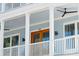 Charming porch view with double doors, ceiling fan, and natural light at 74 Sandbar Ln, Folly Beach, SC 29439